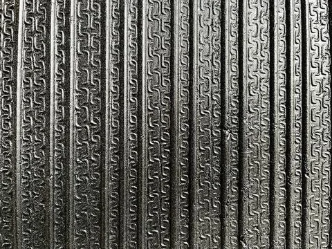 Texture of black rubber mat surface with vertical grooved pattern for non-slip Stock Photos