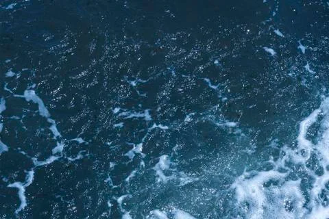 Texture of Black Sea. Blue frothy surface of sea water. Background shot of aq Stock Photos