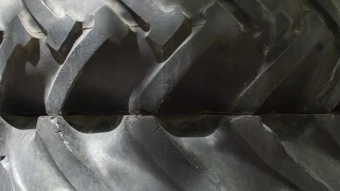 Texture of black stacked tractor wheels Stock Photos