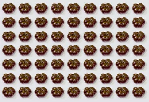 Texture of black tomatoes on white background Stock Photos