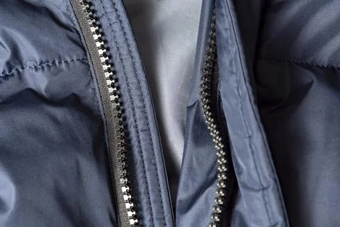 Texture of black warm down jacket with zipper as background, close-up Stock Photos