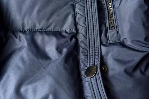 Texture of black warm down jacket with zipper as background, close-up Stock Photos