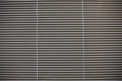 Texture of blinds. Horizontal stripes. Light through blinds. Stock Photos