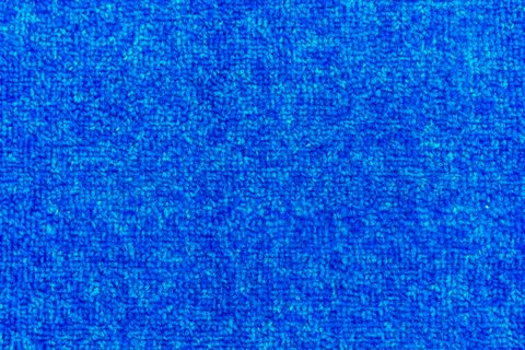 Texture of a blue carpet with dense weaving. Stock Photos
