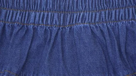 Texture of blue denim jeans with strings and stitching Stock Photos