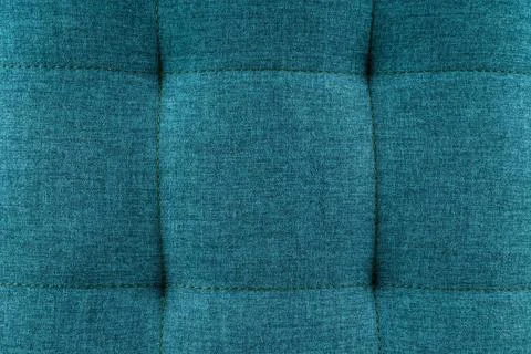 Texture blue fabric. Background of a soft pouf. Stock Photos