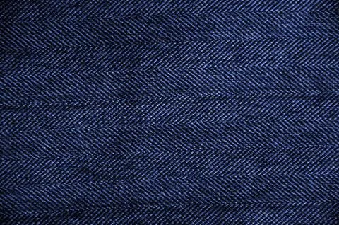 Texture of blue jeans as a background. Stock Photos