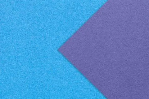 Texture of blue paper background, half two colors with violet arrow, macro. Stock Photos