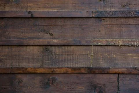 The texture of the boards is dark brown. Stock Photos