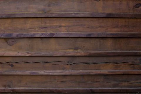 The texture of the boards is dark brown. Stock Photos