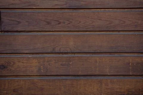 The texture of the boards is dark brown. Stock-Fotos