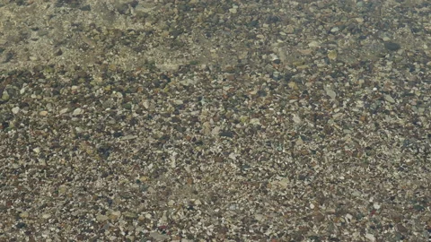 The texture of the bottom. Many small stones are visible under the clear water 스톡 동영상 166156617