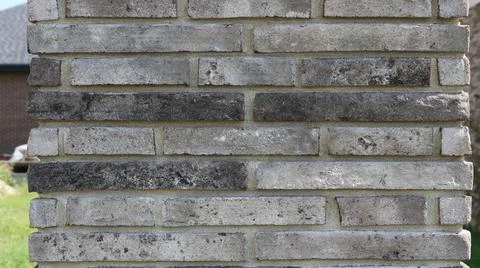 Texture of a brick column made of narrow gray clinker bricks Stock-Fotos