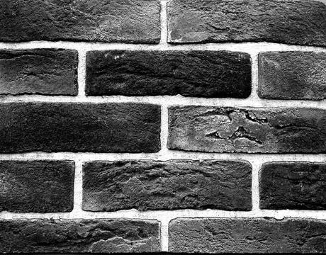 The texture of the brick wall is close to the background. brick wall black and Stock Photos