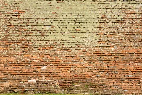 Texture of brick wall full of moss, architectural background Stock Photos