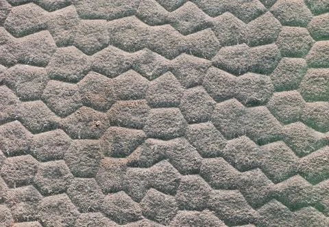 A texture of a brick wall with a hexagonal pattern - background of a gray wal Stock Photos