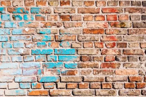 The texture of the brick wall, painted with old paint. Stock Photos