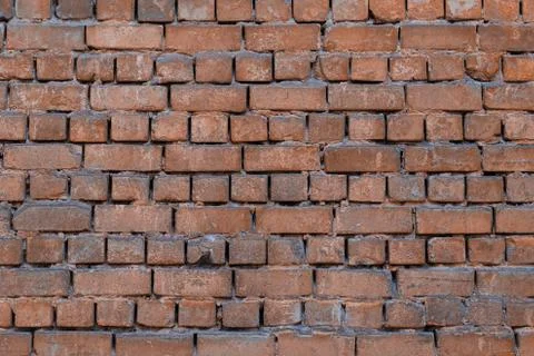 Texture of brick wall with peeling orange-and-gray paint Stock Photos