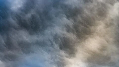 Texture of bright blue dramatic cloudy sky. Stock Photos
