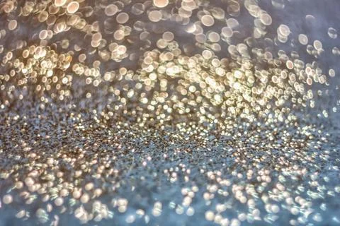 Texture of bright blurry background of sparkles, sequins, sparkling dust, blu Stock Photos