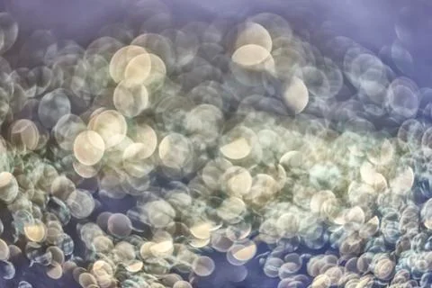 Texture of bright blurry background of sparkles, sequins, sparkling dust, blu Stock Photos