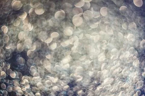 Texture of bright blurry background of sparkles, sequins, sparkling dust, blu Stock Photos