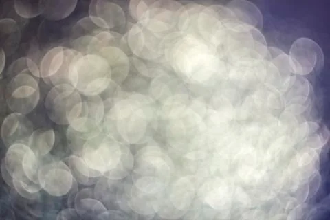 Texture of bright blurry background of sparkles, sequins, sparkling dust, blu Stock Photos