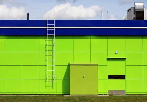 Texture of bright green building with a blue roof utility room near the ga... Photos