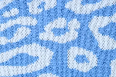 Texture of bright knitted fabric with pattern as background, top view Foto stock