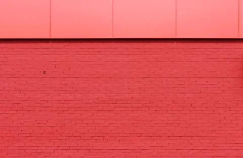 Texture of bright red brick wall on a sunny day. Stock Photos