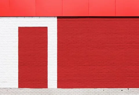 The texture of bright red brick wall with a white stripe and  canopy on  sunny d Stock Photos