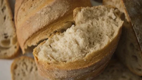 The texture of broken bread. Whirls of freshly baked bread in the bakery. Wooden Stock Footage 148136356