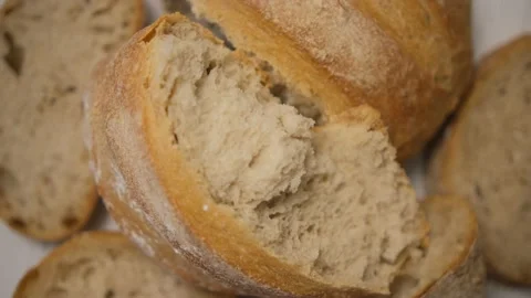 The texture of broken bread. Whirls of freshly baked bread in the bakery. Wooden Stock Footage 148602937