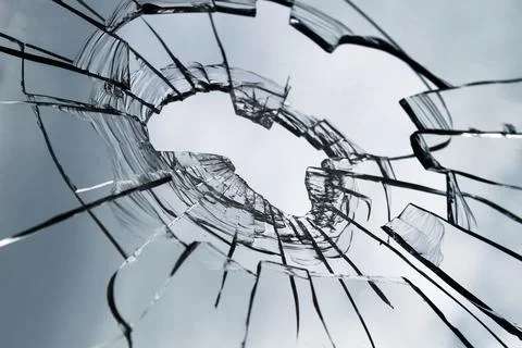 Texture of broken glass for background. Broken window. Close up. Stock Photos