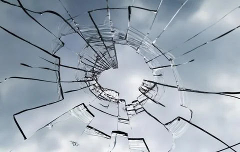 Texture of broken window. Hole in the window glass. Stock Photos