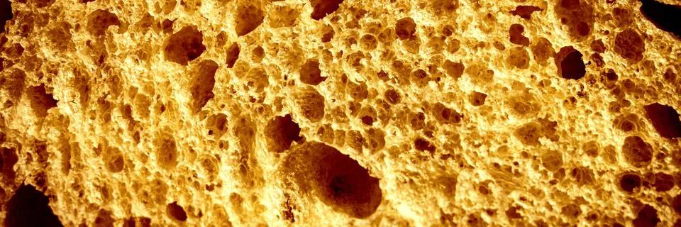 Texture of brown bread as a close up background. backdrop of rough dappled te Stock Photos