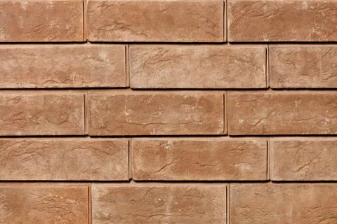 Texture of brown brick tiles on the facade of the wall close-up. Stock Photos