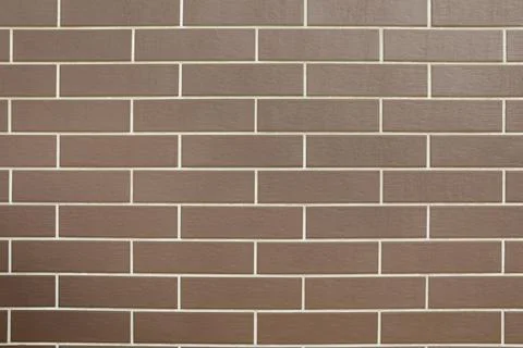 Texture of brown brick wall tiles as background 库存照片