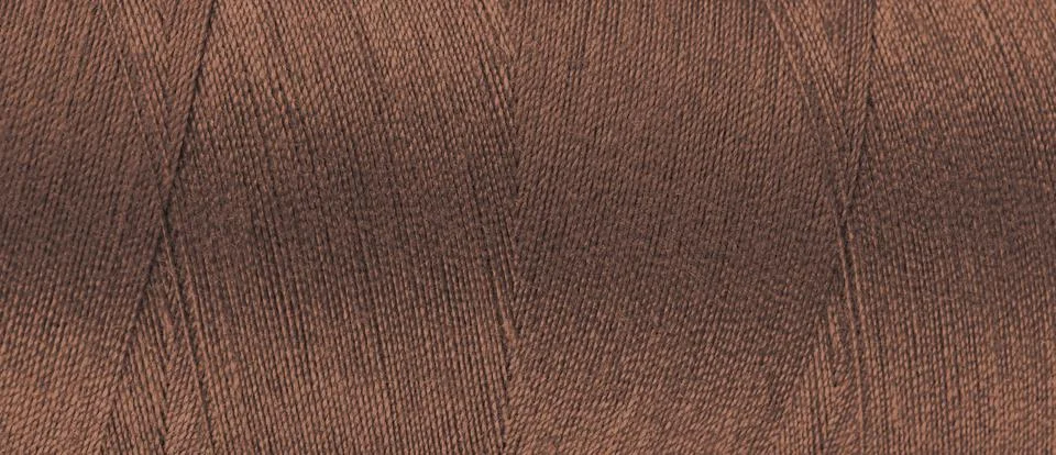 Texture of brown color threads in spool close up, macro. Wide banner, header Stock Photos