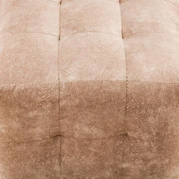 Texture brown fabric. Background of a soft pouf. Stock Photos