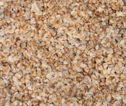 The texture of buckwheat. Background of cooked buckwheat porridge. Stock Photos