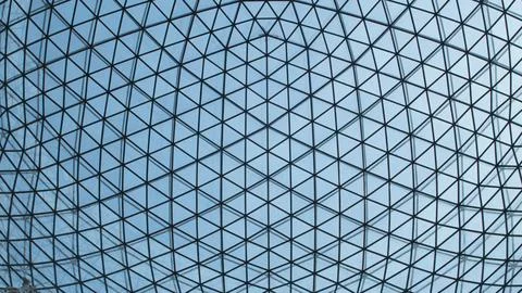 Texture ceiling triangles of a glass dome behind the blue sky Stock Photos