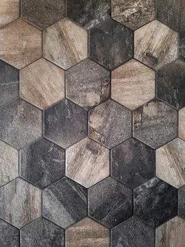 The texture of the ceramic tiles in the form of a hexagon made of brown natural Stock Photos