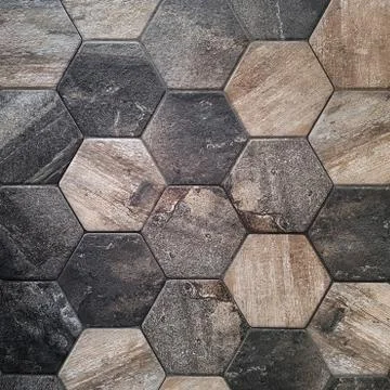 The texture of the ceramic tiles in the form of a hexagon made of brown natural Stock Photos