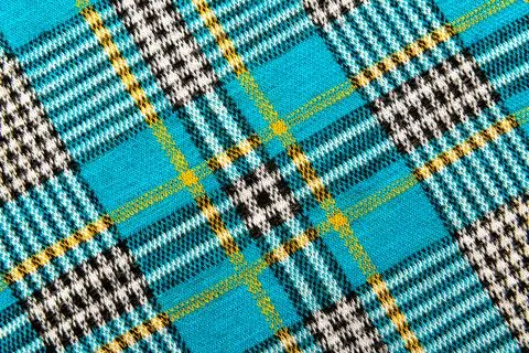 Texture of checkered blue fabric.Textile with intersecting white, black, ye.. Stock Photos