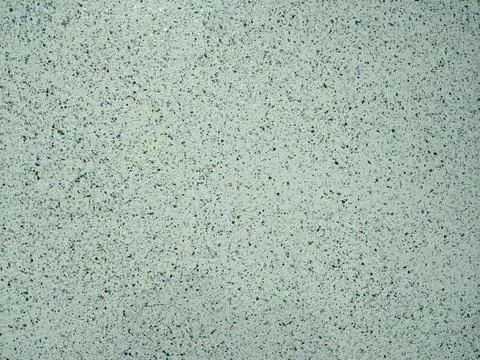 Texture of clean cement plaster on a wall speckled with various colors Stock Photos