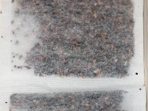 Texture close up of white tea bag with herbal flavour Stock Photos