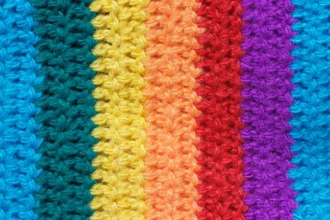 Texture of the cloth is knitted from multi-colored yarn. Stock Photos