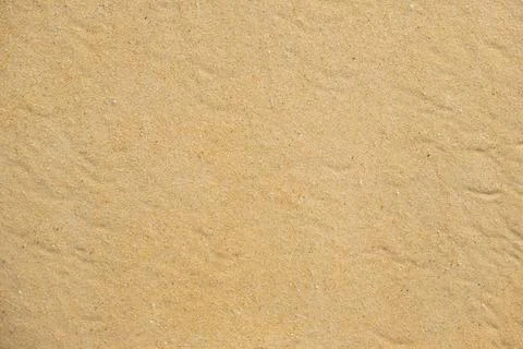 Texture of coarse yellow sand on the beach Stock Photos