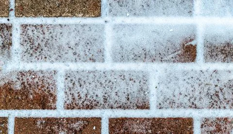 The texture of the cobblestone path covered with the first snow in winter. Foto stock